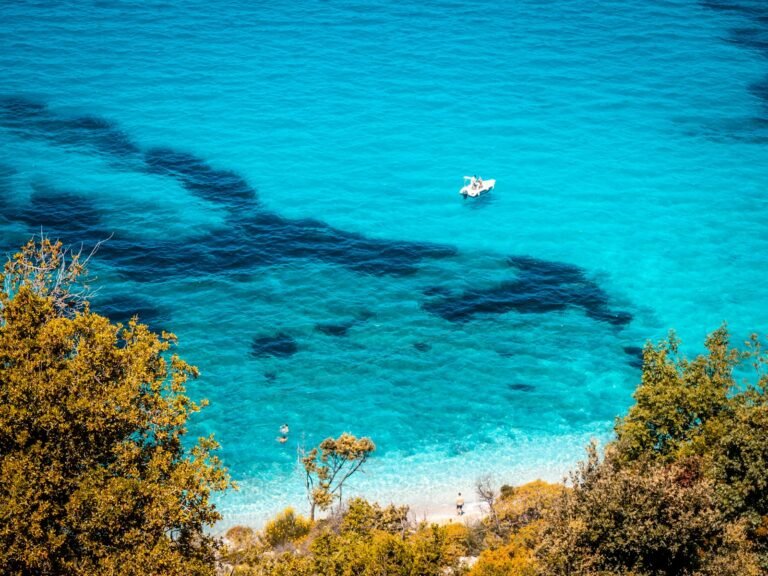 Turquoise water and a small boat off the coast of Ksamil, Albanian Riviera